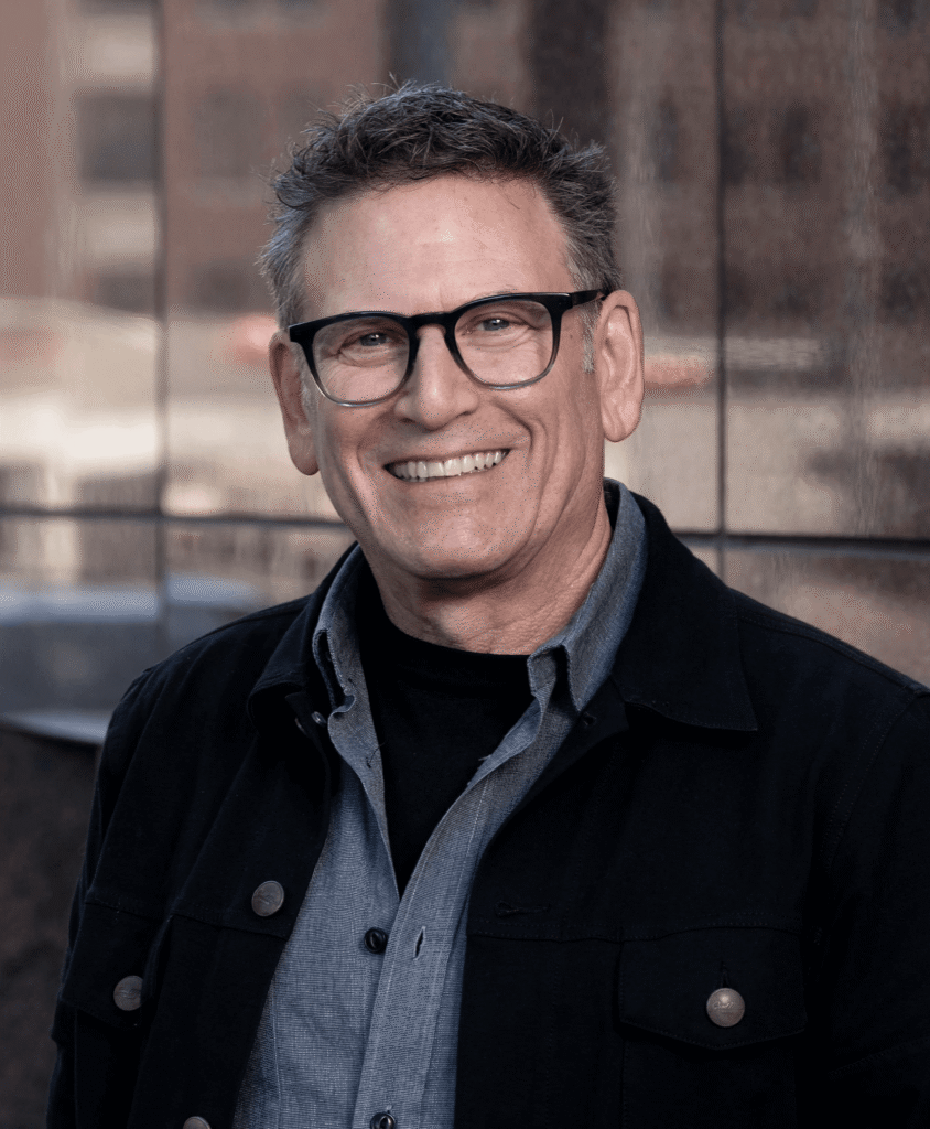 Joel Granoff smiling, wearing a black jacket